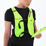 Wearing the Six Peaks Hydration Running Vest in Safety Yellow over a black shirt, a person holds a matching yellow item while looking at it against a plain white background. Brand: Six Peaks.