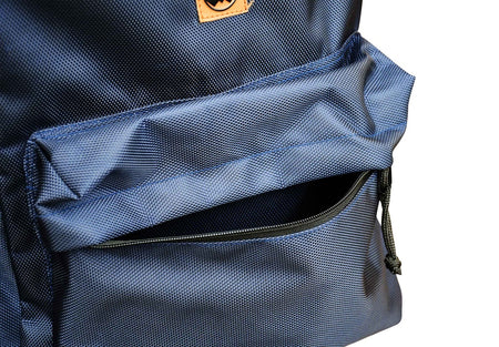 Close-up of the Six Peaks Icon 30 Liter Backpack in blue, showing its textured fabric, black front zipper, and laptop sleeve. The backpack by Six Peaks is set against a plain white background.
