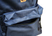 Close-up of the Six Peaks Icon 30 Liter Backpack in blue, showing its textured fabric, black front zipper, and laptop sleeve. The backpack by Six Peaks is set against a plain white background.