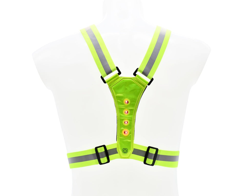 The Six Peaks LED Reflective Vest with Phone Holder features neon yellow fabric, gray stripes, green LEDs, and adjustable black buckles, shown on a transparent mannequin torso for hi-visibility and safety. Brand: Six Peaks.