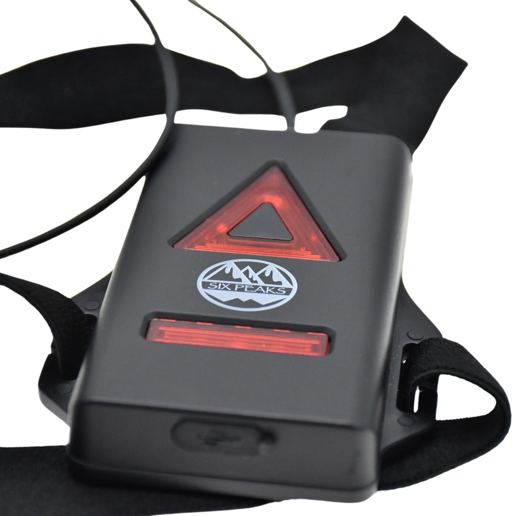Six Peaks Running LED Chest Lamp: black wearable with red triangle and bar-shaped LEDs, Six Peaks logo, and adjustable black straps—designed for outdoor safety.