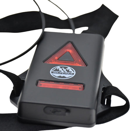 Six Peaks Running LED Chest Lamp: black wearable with red triangle and bar-shaped LEDs, Six Peaks logo, and adjustable black straps—designed for outdoor safety.