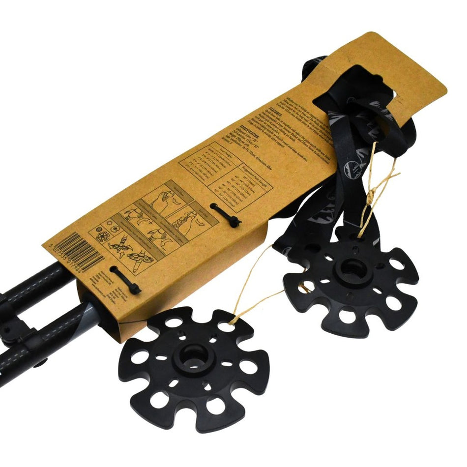 The Six Peaks Stride Walking Poles by Six Peaks come partially packaged in brown cardboard with large black snow baskets and illustrated instructions—an essential addition to your hiking gear.