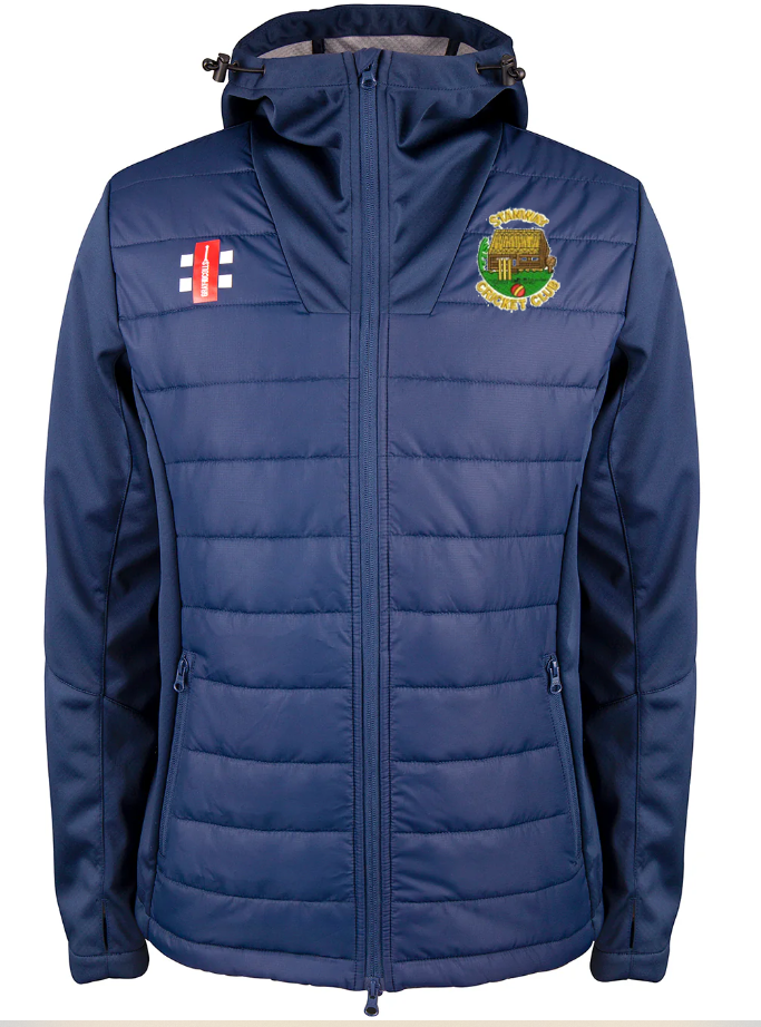 The Stanway CC Pro Performance Full Zip Jacket by Gray Nicolls is a navy, water repellent, hooded jacket with zip-up front and side pockets. Made from recycled polyester, it features a club crest left chest and a red/white logo with blue lines on the right.