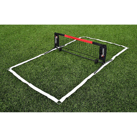 The Precision Mini Foot Tennis Set by Precision Training includes a collapsible black net with red and white branding and white boundary lines, which outline a small rectangular court for skill training on grass.