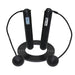 The Urban Fitness Smart Skipping Rope by Urban Fitness features black handles—one with a calorie-tracking screen and the other labeled with the brand. This versatile rope has interchangeable cord and weighted ball ends, shown coiled on a white background.