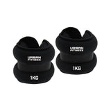 Two black Urban Fitness Neoprene Ankle/Wrist Weights, each labeled "Urban Fitness" and "1KG," can be used on the wrists or ankles. Both weights are shown side by side on a white background.