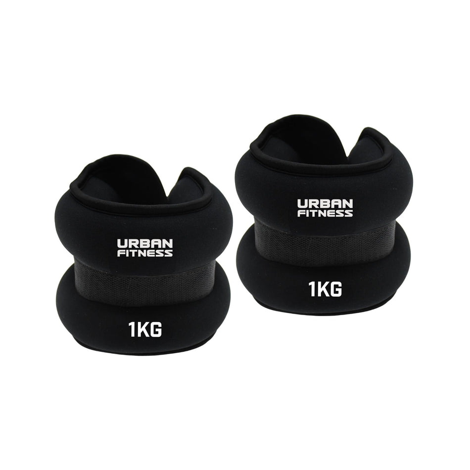 Two black Urban Fitness Neoprene Ankle/Wrist Weights, each labeled "Urban Fitness" and "1KG," can be used on the wrists or ankles. Both weights are shown side by side on a white background.