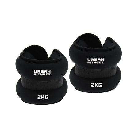 Two black Urban Fitness Neoprene Ankle/Wrist Weights, each 2KG, are shown against a white background. Featuring a soft padded design and secure strap, these versatile weights by Urban Fitness are perfect for wrists or ankles.