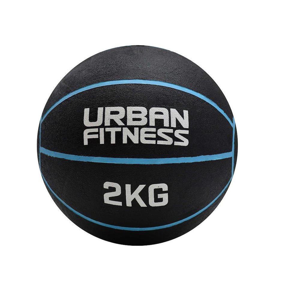 The Urban Fitness Medicine Ball, a black rubber ball with blue lines and "URBAN FITNESS 2KG" in white, is designed to enhance explosive power and functional fitness. Brand: Urban Fitness. Set on a clean white background.