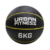 The Urban Fitness Medicine Ball, in black rubber with yellow lines and "URBAN FITNESS 6KG" printed in white, is ideal for functional fitness routines to increase explosive power.