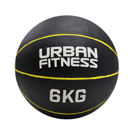 The Urban Fitness Medicine Ball, in black rubber with yellow lines and "URBAN FITNESS 6KG" printed in white, is ideal for functional fitness routines to increase explosive power.