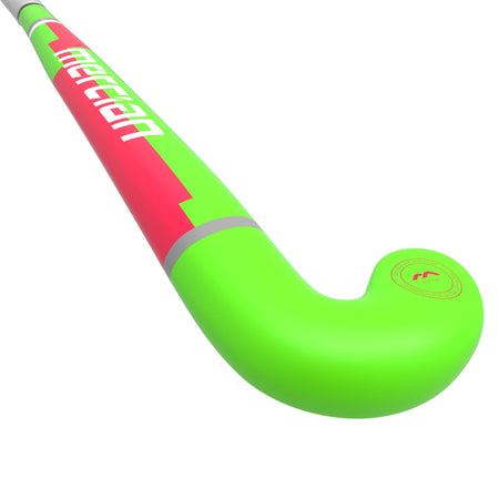 A close-up of the Mercian Genesis Wood Hockey Stick (22"–32"), featuring red and white accents, the curved end, and partial shaft with visible Mercian branding.