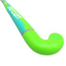 A close-up of the Mercian Genesis Wood Hockey Stick (22"–32") by Mercian, in bright green and turquoise with "MACHINA" printed on it, shown against a white background.