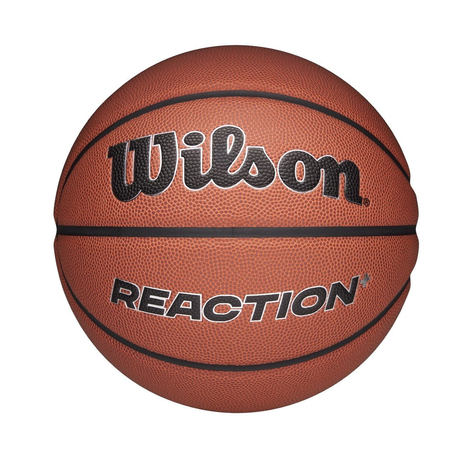 The Wilson Reaction Plus Basketball features a brown composite cover with black lines and "Wilson" boldly above "REACTION." Suitable for indoor and outdoor play, it is shown against a plain white background.