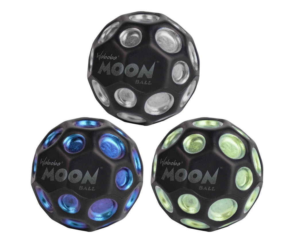 Three Waboba Dark Side of Moon Balls by Waboba, featuring black dimpled surfaces and metallic dots in silver, blue, and green, are displayed in a triangular arrangement on a white background.