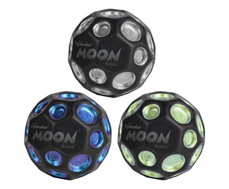 Three Waboba Dark Side of Moon Balls by Waboba, featuring black dimpled surfaces and metallic dots in silver, blue, and green, are displayed in a triangular arrangement on a white background.