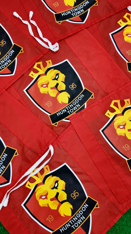 Custom Printed Corner Post Flags (Single Colour Flag & Logo) by Martin Berrill Sports are displayed on green grass, some overlapping, showing how these stylish personalised flags add distinction to any event or match day.