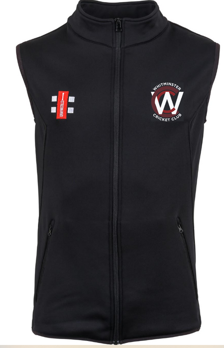 The Whitminster CC Black Storm Bodywarmer by Gray Nicolls is a sleeveless zip-up vest with the club logo on the left chest, red and white sponsor patch on the right, two zippered front pockets, and stretch micro-fleece for comfort.