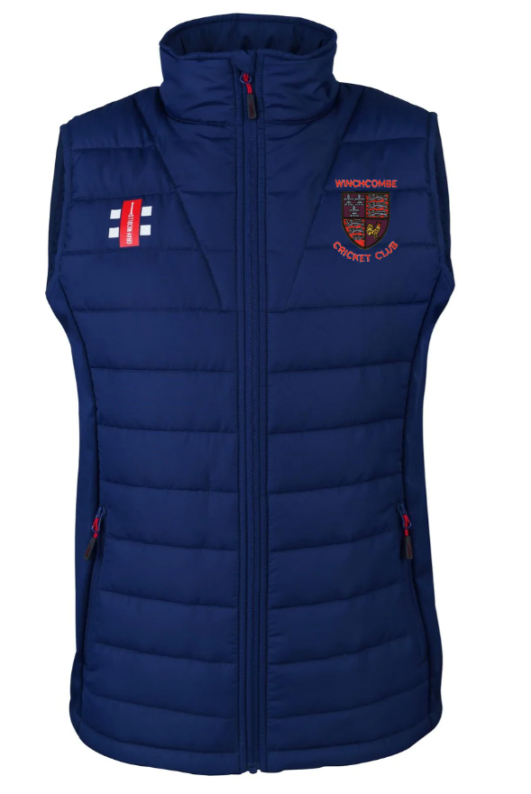 The Gray Nicolls Winchcombe CC Pro Performance Bodywarmer is navy blue with a front zipper, two zippered pockets, a red and gold embroidered club crest, and an English flag patch on the left side.