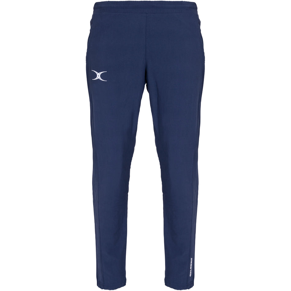 The Gilbert Womens Synergie V3 Trouser by Gilbert features a dark navy color, elastic waistband, white curved logo on the left thigh, and a small vertical white text logo near the ankle, shown against a white background.