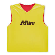 The Mitre Reversible Training Bib is a sleeveless yellow V-neck sports bib with 'Mitre' in black on the front and a red inner lining, offering stylish reversible use for versatile training.