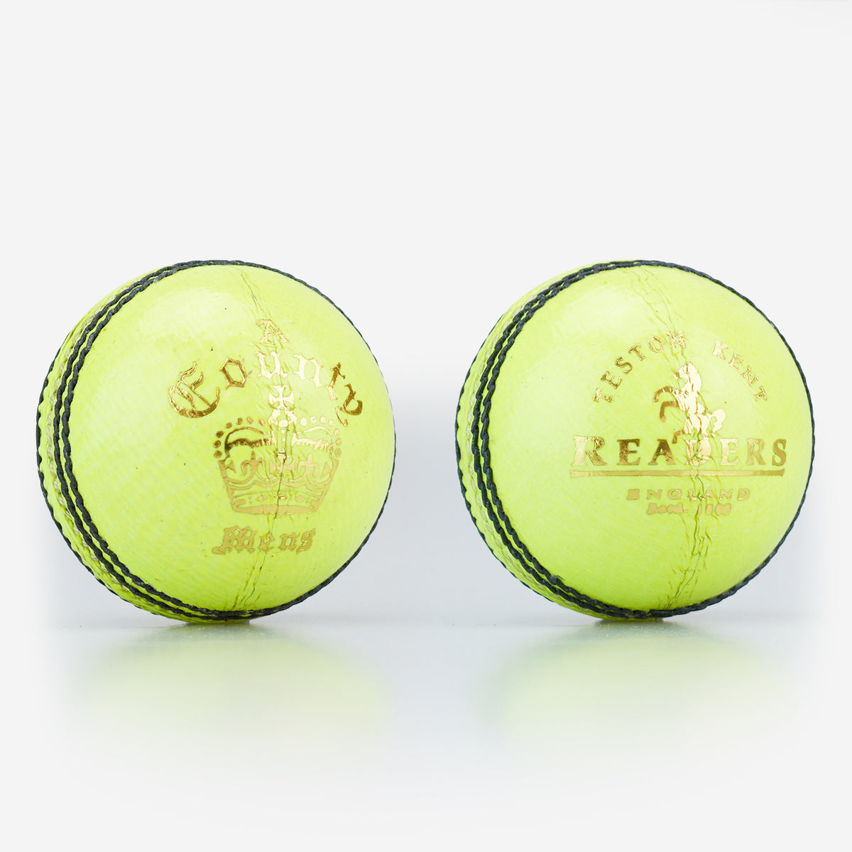 Two Readers County Crown Coloured Cricket Balls in yellow, featuring black stitching, gold text, and a crown logo from Readers, are placed side by side on a white background—ideal for evening matches or training sessions.