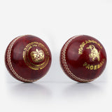 Two red Kookaburra Pace Cricket Balls by Kookaburra, with white stitching and gold branding, are displayed side by side on a plain white background. Each is hand sewn with a durable hide cover.