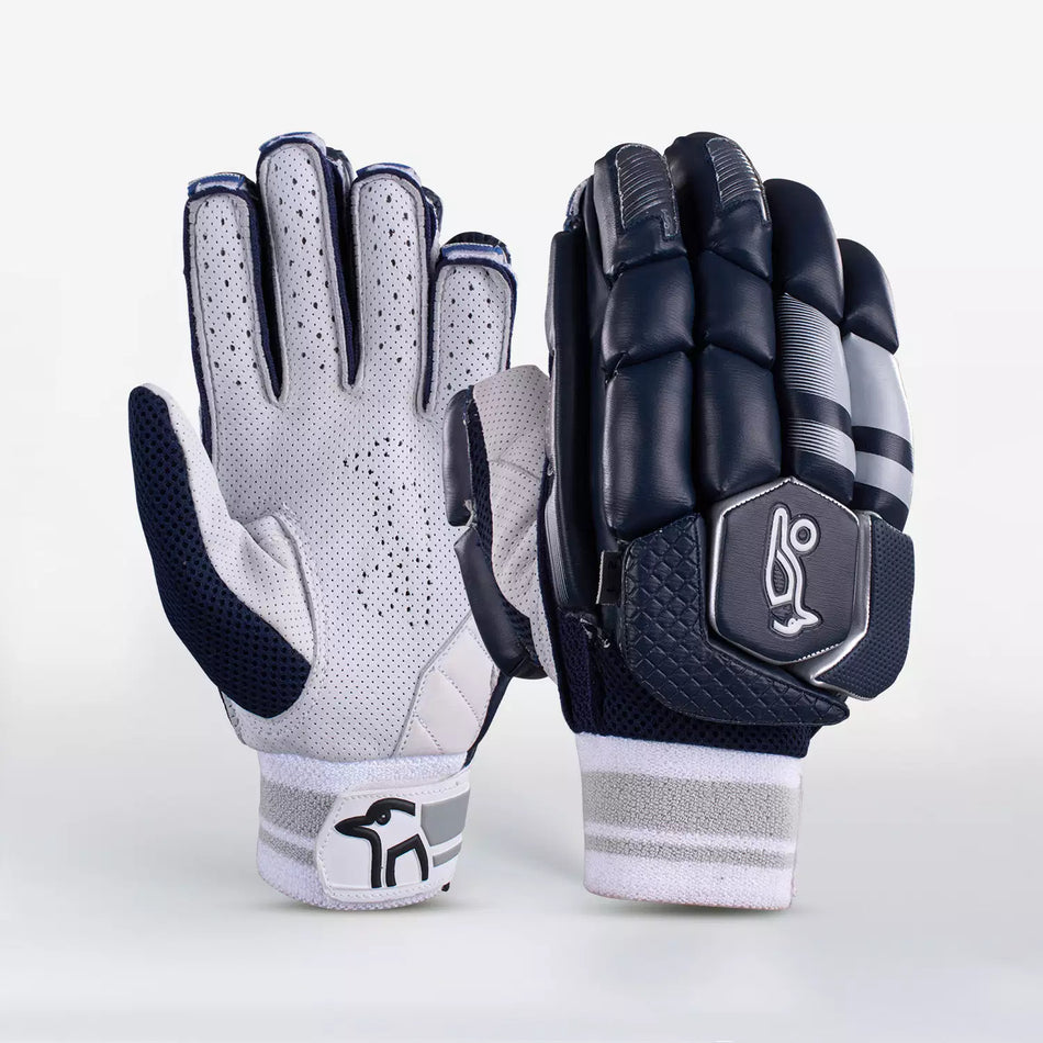 The Kookaburra 2.1 T/20 Batting Gloves by Kookaburra feature a navy palm side in supple sheep leather with perforations, and a padded back with black, grey, and white high-density foam detailing plus a stylized logo.