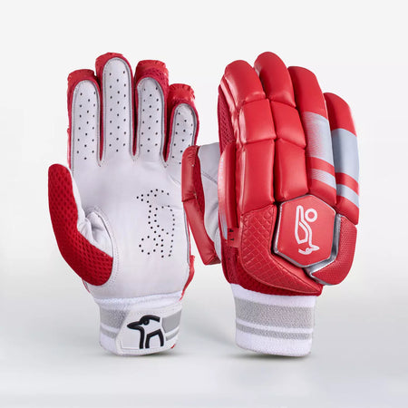 The Kookaburra 4.1 T/20 Batting Gloves by Kookaburra are shown in red, featuring ventilation holes and textured grip on the palm, finger protection, a padded back with gray accents, wrist logo, and premium leather construction.