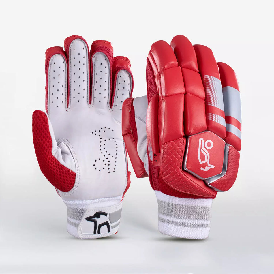 The Kookaburra 4.1 T/20 Batting Gloves by Kookaburra are shown in red, featuring ventilation holes and textured grip on the palm, finger protection, a padded back with gray accents, wrist logo, and premium leather construction.
