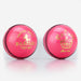 Two pink Readers County Crown Coloured Cricket Balls with black stitching and shiny leather surfaces, ideal for training or evening matches, are set on a white background. Each features distinctive gold branding: the Readers logo and a crown.