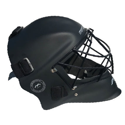 Mercian Genesis Hockey Helmet in black, featuring a fibreglass shell, cats-eye grill with metal faceguard, adjustable straps, and side logo for superior protection.