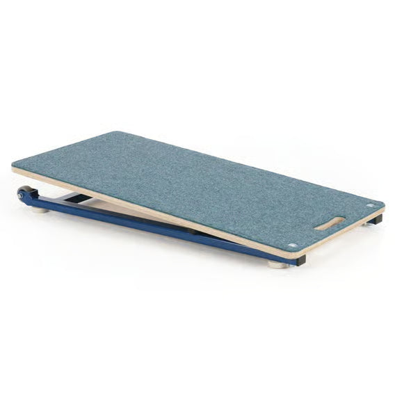 The Niels Larsen Junior Springboard, by Niels Larsen, is a birch ply bench with a blue textured surface, blue metal frame on small wheels, an angled end for elevation, and a handle cutout for easy carrying.