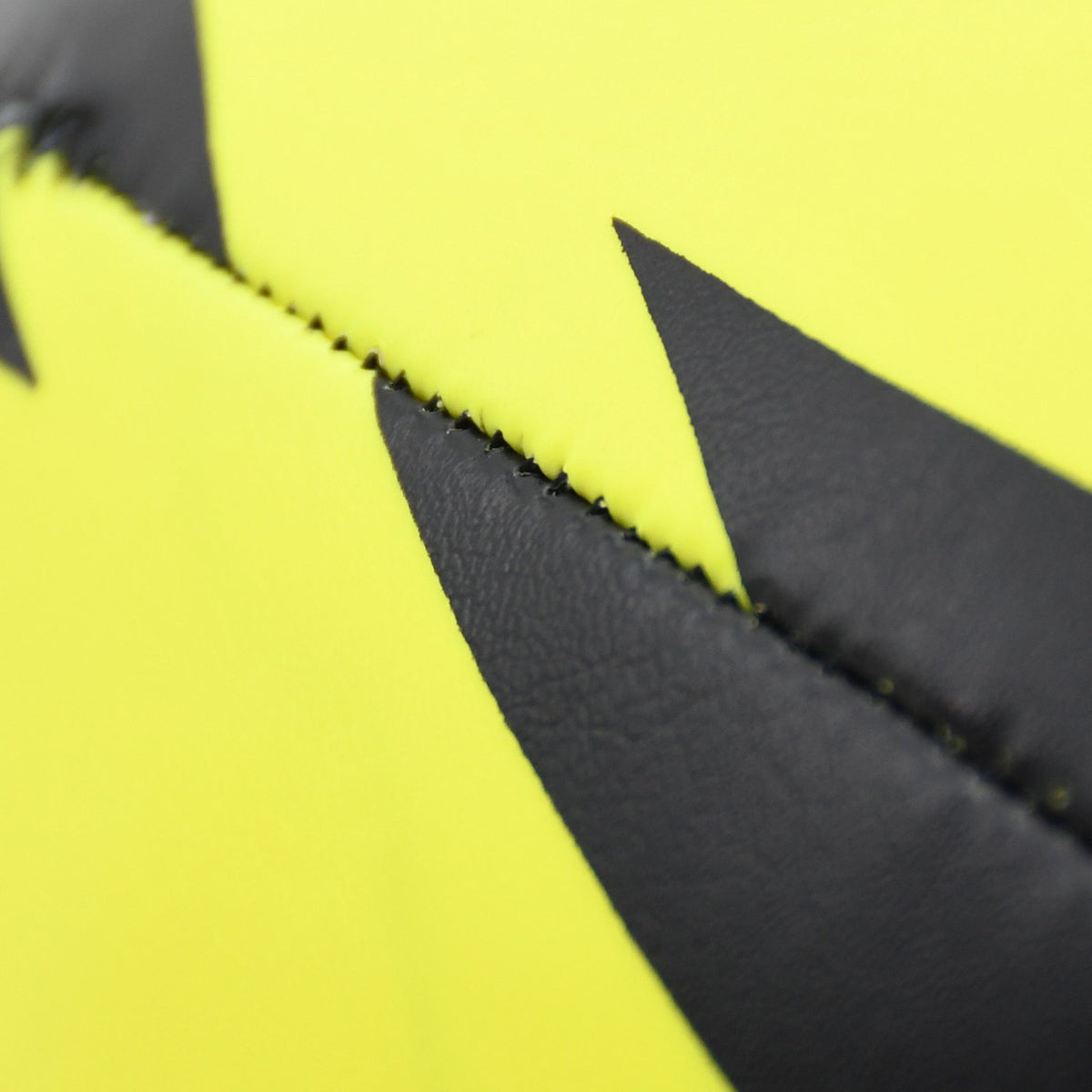 Close-up of the yellow foam and black lightning-shaped panel on the Soft Play Rugby Ball