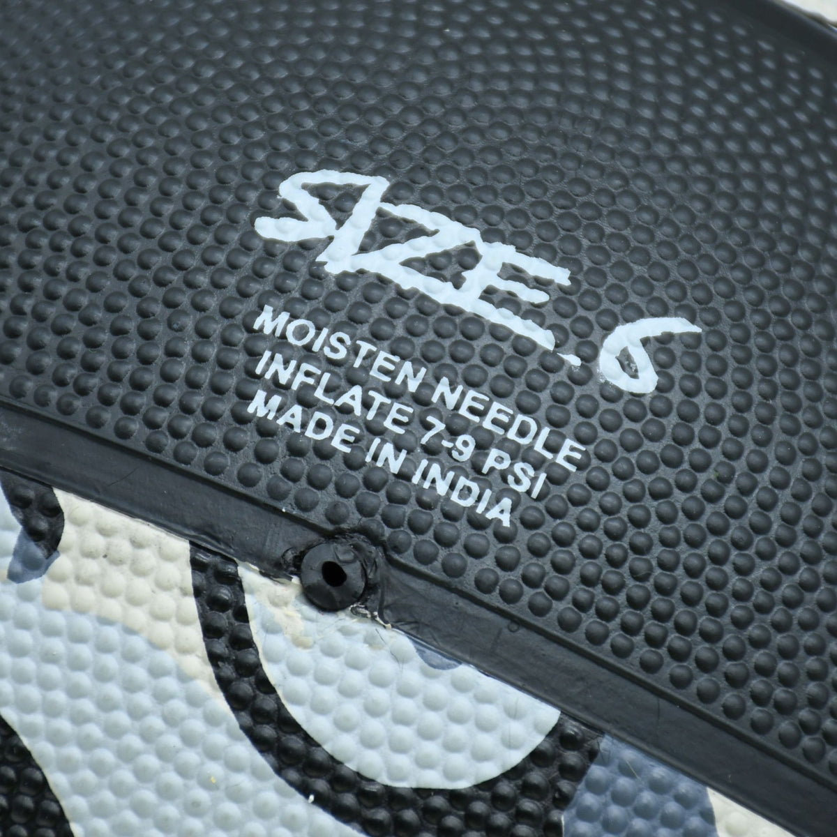 Close-up of the size 6 marking and inflation hole on a Black/Grey Midwest Street Basketball