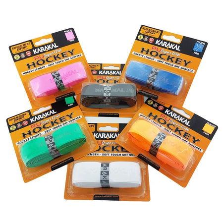 Six packages of Karakal XL PU Super Hockey Grip by Karakal, in assorted colors (pink, green, black, blue, orange, and white), are displayed on a white background. Each package features the brand and product details, emphasizing the cushioned PU grip engineered for superior comfort and control.
