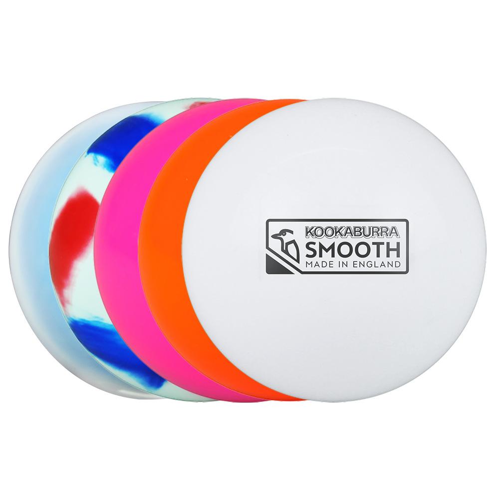Four Kookaburra Burra Smooth Hockey Balls—one white with Kookaburra label, plus orange, pink, and blue-white-red marbled patterns—are lined up in a row, smooth and slightly overlapping.