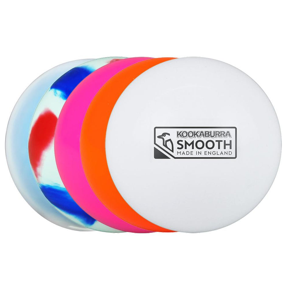 Four Kookaburra Burra Smooth Hockey Balls—one white with Kookaburra label, plus orange, pink, and blue-white-red marbled patterns—are lined up in a row, smooth and slightly overlapping.