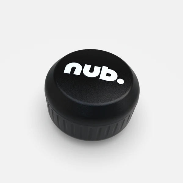 A black, round plastic cricket bat handle attachment by nub Sports, featuring "nub." in white lowercase letters on top, is shown against a plain white background. Product name: nub - Black.