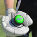 A person wearing a white cricket glove holds the nub - Green Thunder by nub Sports, a popular silicone cricket bat grip with a bright green top and purple "nub." lettering. The background features a grassy outdoor area.