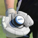 A person wearing white cricket gloves holds a nub Sports nub - White cricket bat handle attachment in their palm while standing on a sports field.