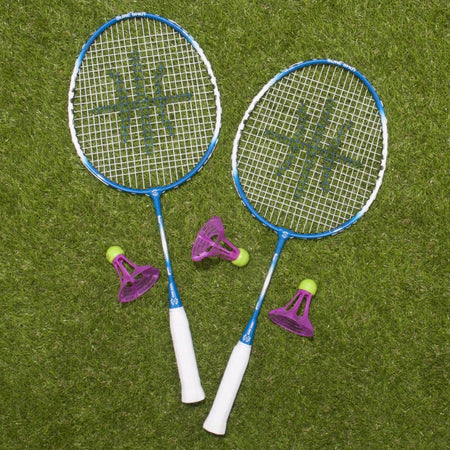 The Sure Shot Quick Fit Badminton 3m Senior Pack - OD Shuttles by Sure Shot includes two blue and white rackets and two purple-green shuttlecocks, making it perfect for badminton fun on green grass outdoors.