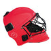 The Mercian Genesis Hockey Helmet in red features a durable fibreglass shell, black Cats-eye Grill face cage, and adjustable black straps, shown here in side profile for superior protection.