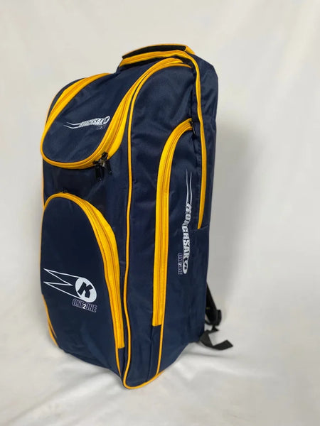 The Katchet KoachSak One2One, a spacious navy/yellow cricket equipment bag with bold white logo, multiple compartments, and yellow accents, stands upright on a white background—ideal for coaches or one-to-one sessions.