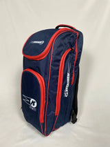 The Katchet KoachSak One2One is a navy/red cricket coach bag with multiple zippered compartments and white Katchet logos, ideal for one-to-one coaching, shown standing upright against a plain white background.