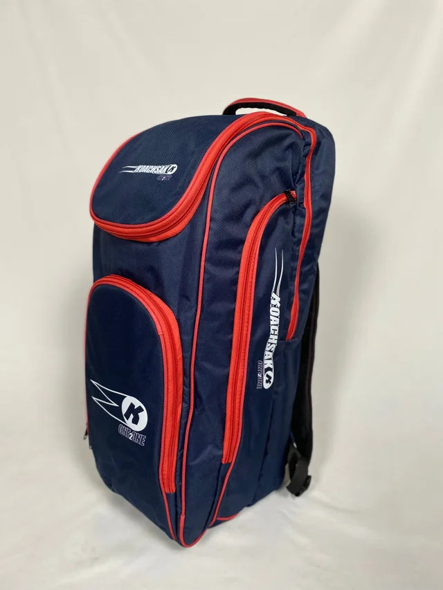 The Katchet KoachSak One2One is a navy/red cricket coach bag with multiple zippered compartments and white Katchet logos, ideal for one-to-one coaching, shown standing upright against a plain white background.