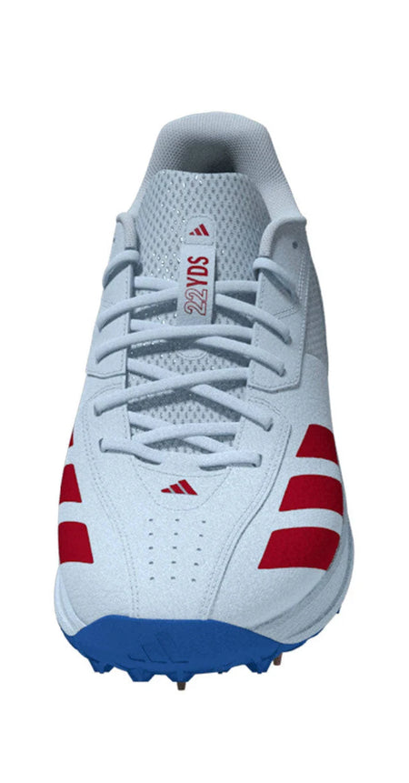 A front-facing view of the Adidas 22YDS White/Red/Royal Cricket Spikes 2026—a light grey cricket shoe with red side stripes, a blue sole, and "22YDS" on the tongue—ideal for fans of Adidas cricket shoes.