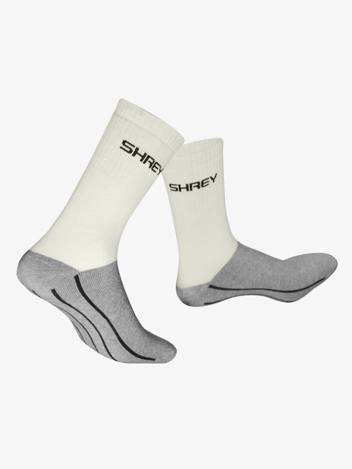 The Shrey Original Performance Socks (Senior) Twin Pack includes white and gray sports socks with reinforced gray heels, toes, and soles, black support lines, and "SHREY" near the top. They’re anti-odour for all-day freshness.