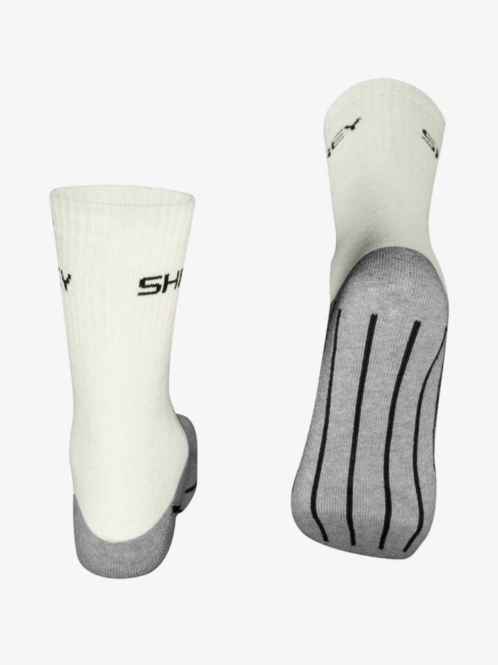 White crew socks with gray heels and toes, shown from back and sole view. SHREY is printed in black near the top, with black grip lines on the sole. Shrey Original Performance Socks (Senior) Twin Pack delivers comfort and style.